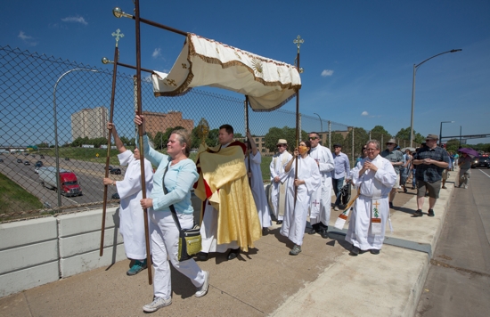 Father R.J. Fichtinger of St. Thomas More Parish in St. Paul, Minn., carries a monstrance with the Blessed Sacrament over the Interstate 94 bridge in St. Paul June 6, 2021, during a procession that began a mile away at St. Peter Claver Church to celebrate the feast of Corpus Christi.