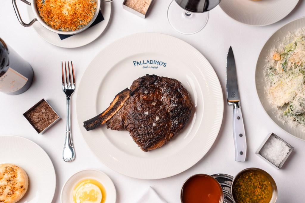 a table with steak and sides on top