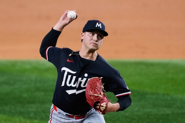 Minnesota Twins pitcher Mike Paredes throws to the Texas Rangers in the second inning of a baseball game in Arlington, Texas, Monday, June 15, 2026. (AP Photo/Tony Gutierrez)