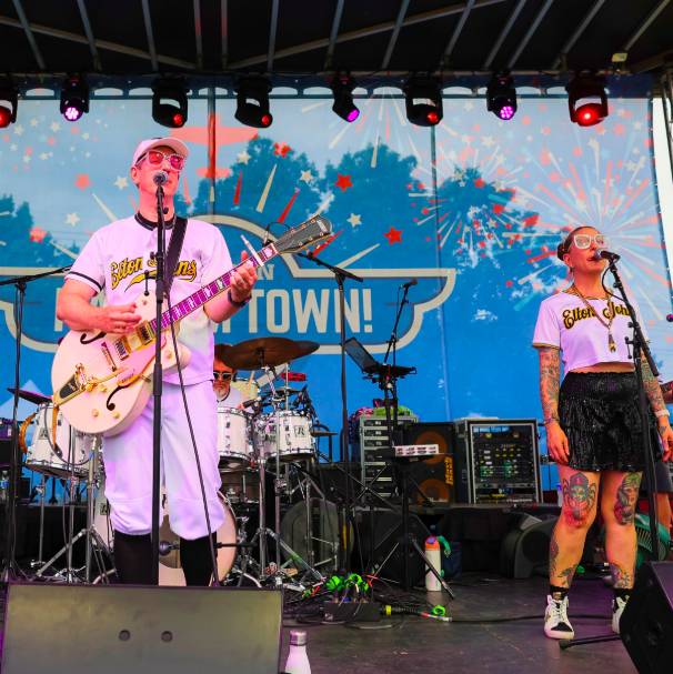 Image shows musicians playing on stage at Addison Kaboom Town!
