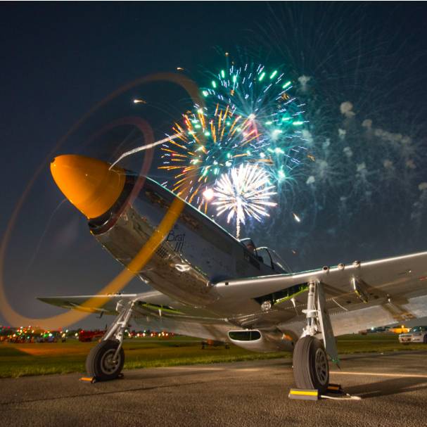 Image shows a plane with fireworks in the background at Addison Kaboom Town!