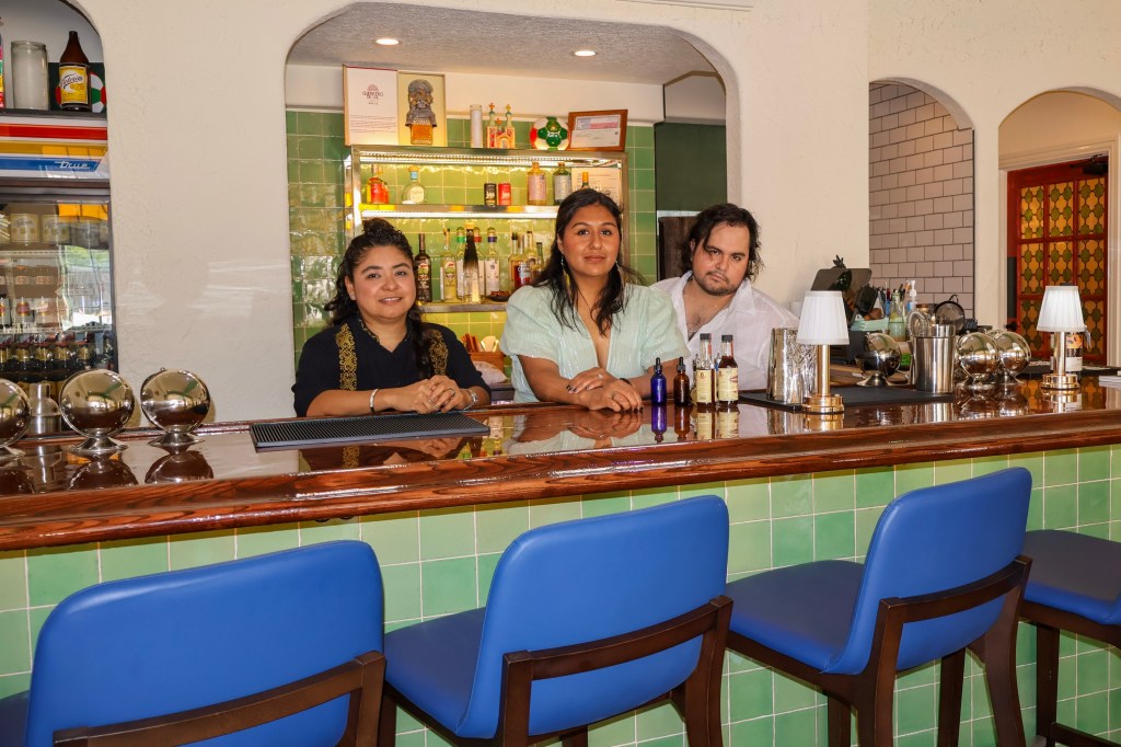 Karla Soria, Alexandra Hernandez and Saul Hernandez standing behind the bar at Sor Juana