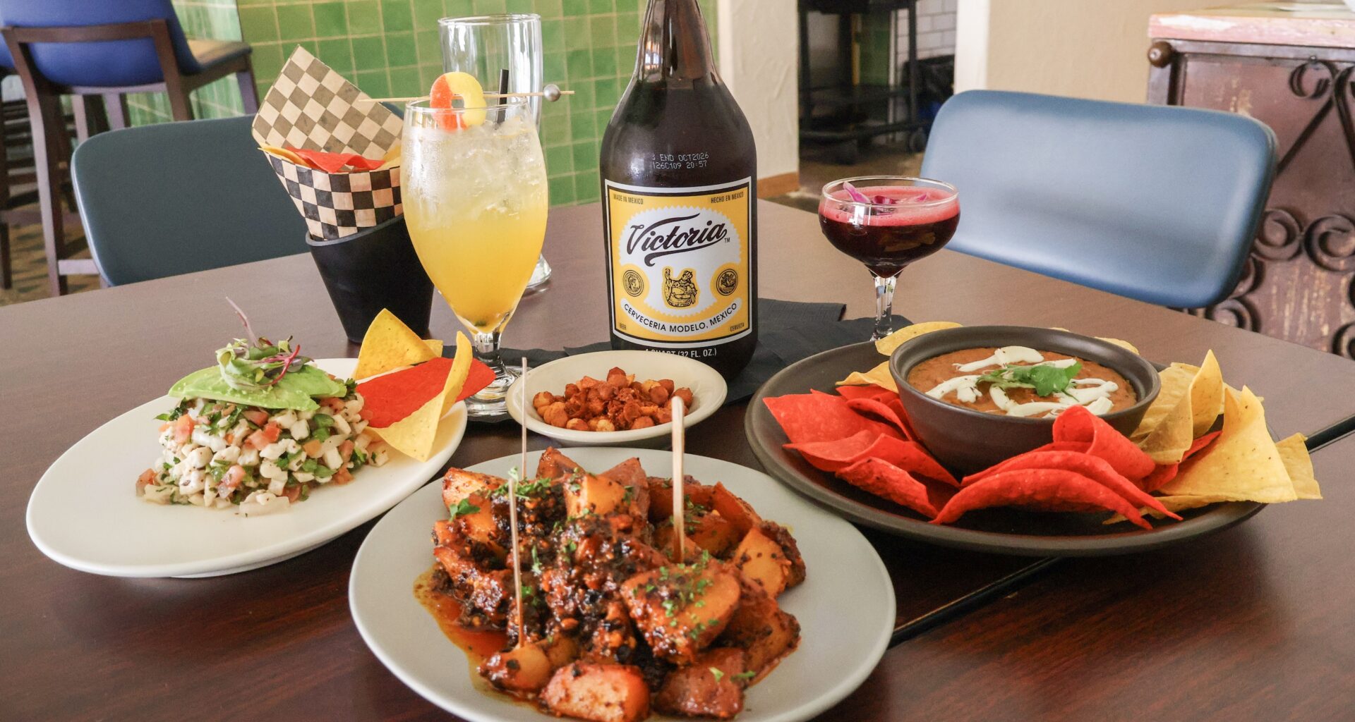 a table filled with botanas and mexican drinks