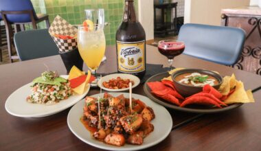 a table filled with botanas and mexican drinks