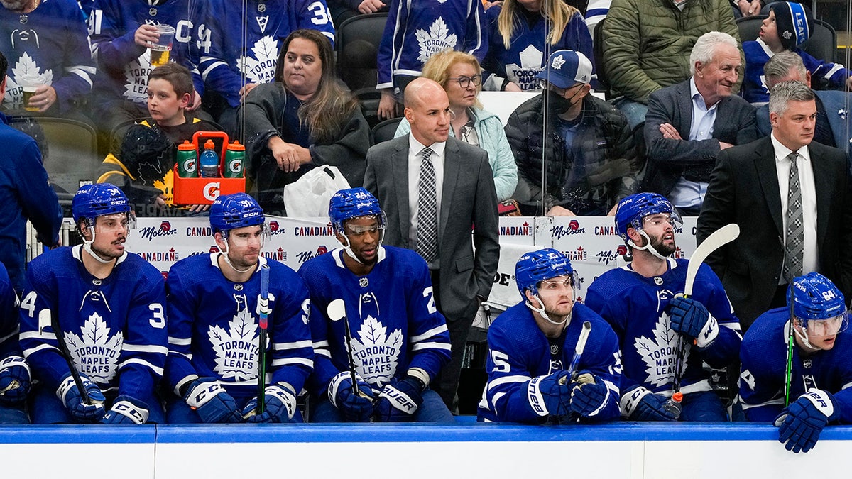 Spencer Carbery assistant coach of the Toronto Maple Leafs looking on from the bench during a game.