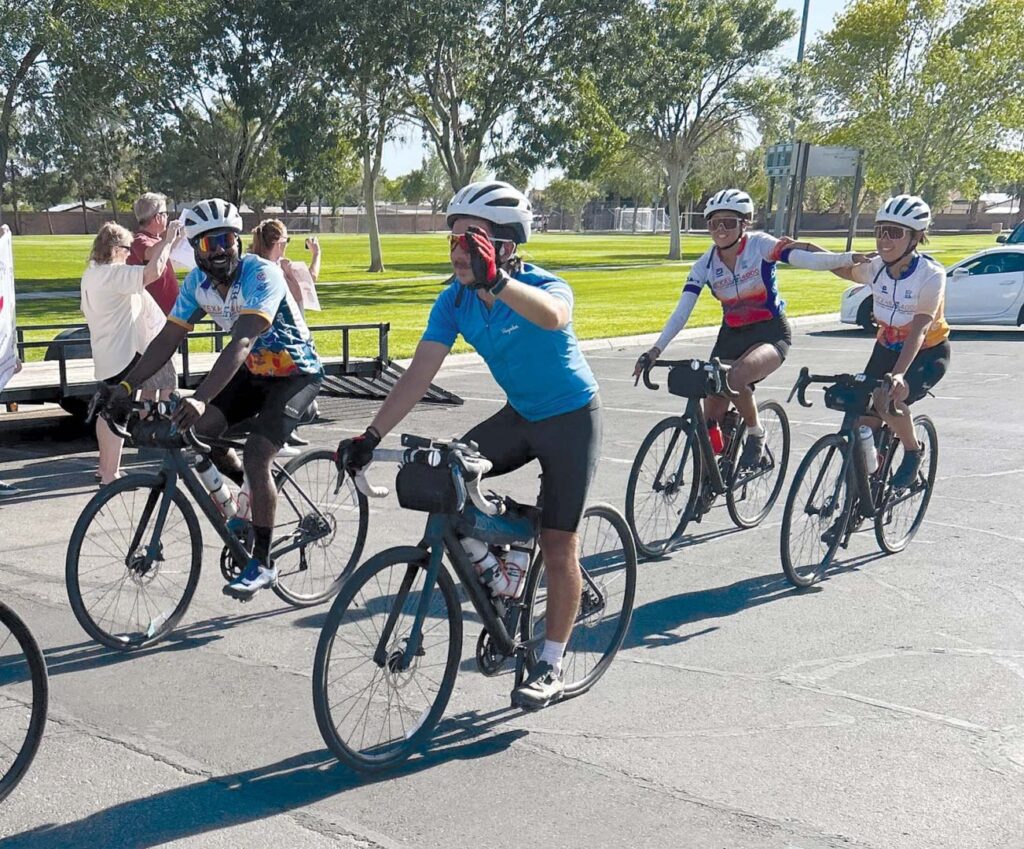 A team of nearly 20 cyclists makes its way through Mesquite en route to Alaska, May 17.