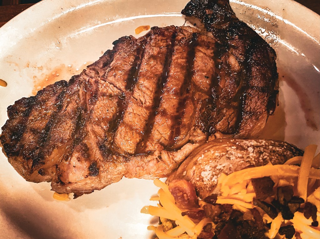 Texas Roadhouse steak meal with a baked potato
