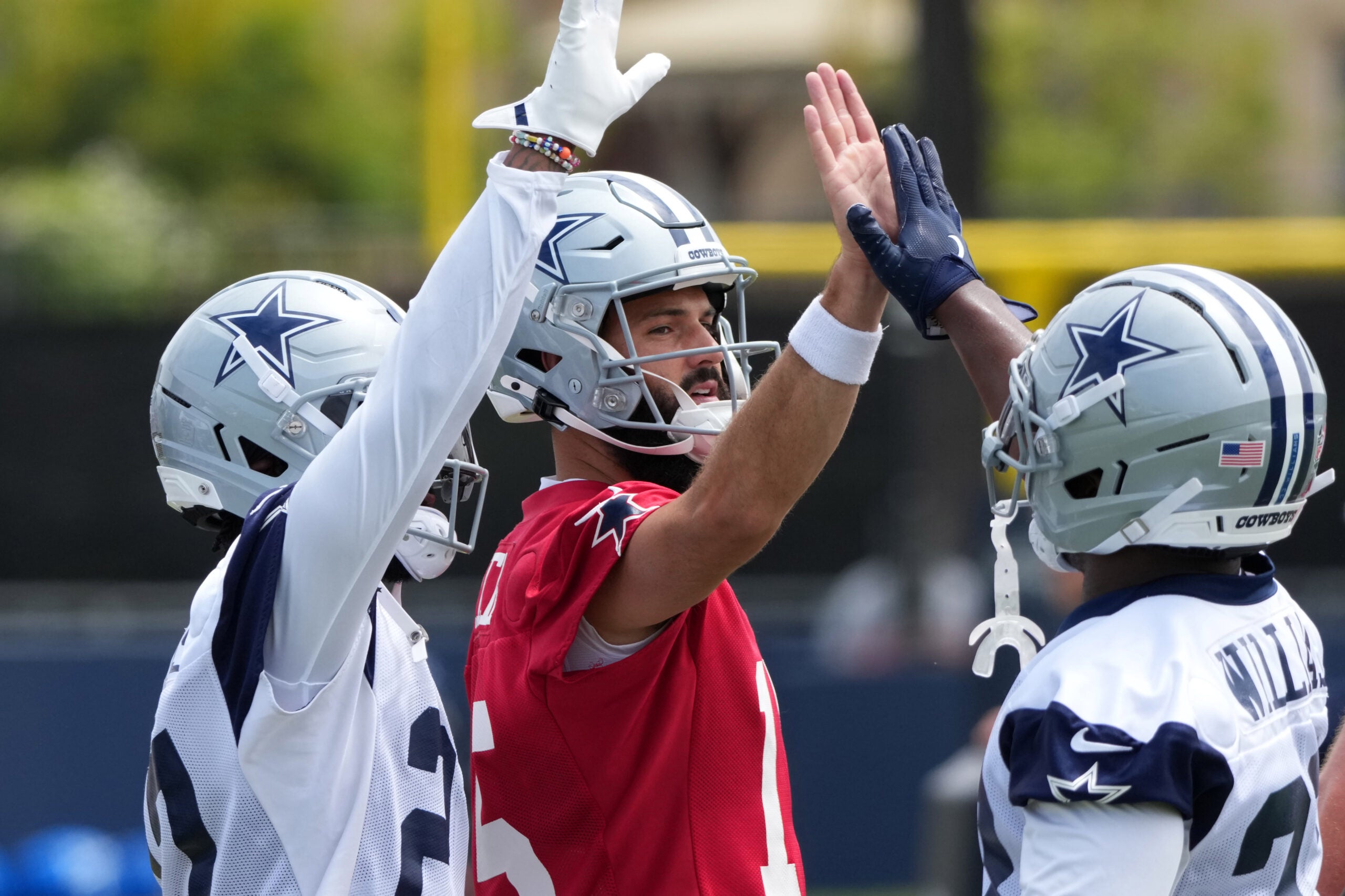 Jul 22, 2025; Oxnard, CA, USA; Dallas Cowboys quarterback Will Grier (15) with running back Javonte Williams (33) during training camp at the River Ridge Fields.