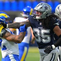 Aug 9, 2025; Inglewood, California, USA; Dallas Cowboys linebacker Marist Liufau (35) grabs a hold of Los Angeles Rams running back Cody Schrader (32) following a play in the first half at SoFi Stadium.