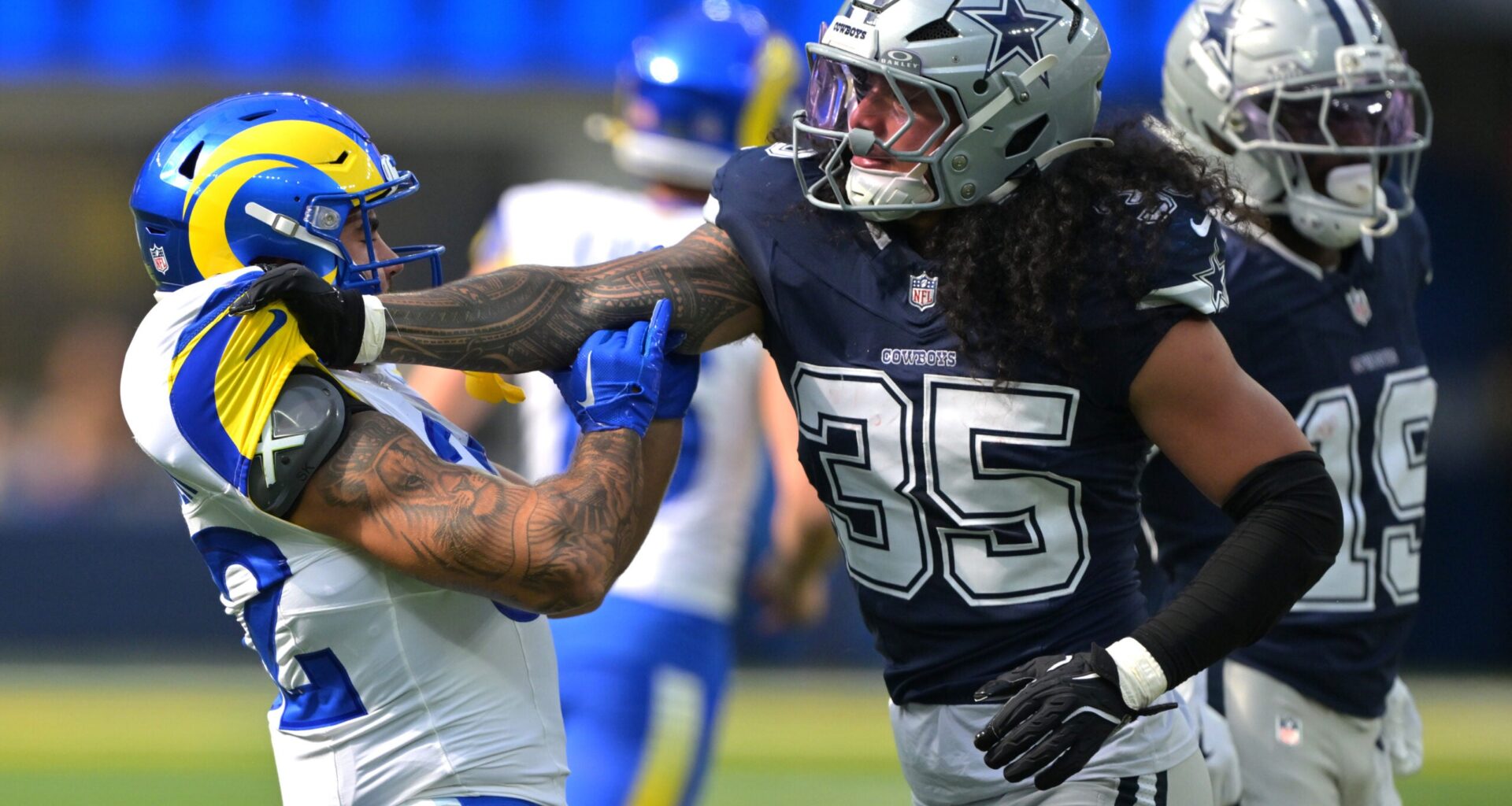 Aug 9, 2025; Inglewood, California, USA; Dallas Cowboys linebacker Marist Liufau (35) grabs a hold of Los Angeles Rams running back Cody Schrader (32) following a play in the first half at SoFi Stadium.