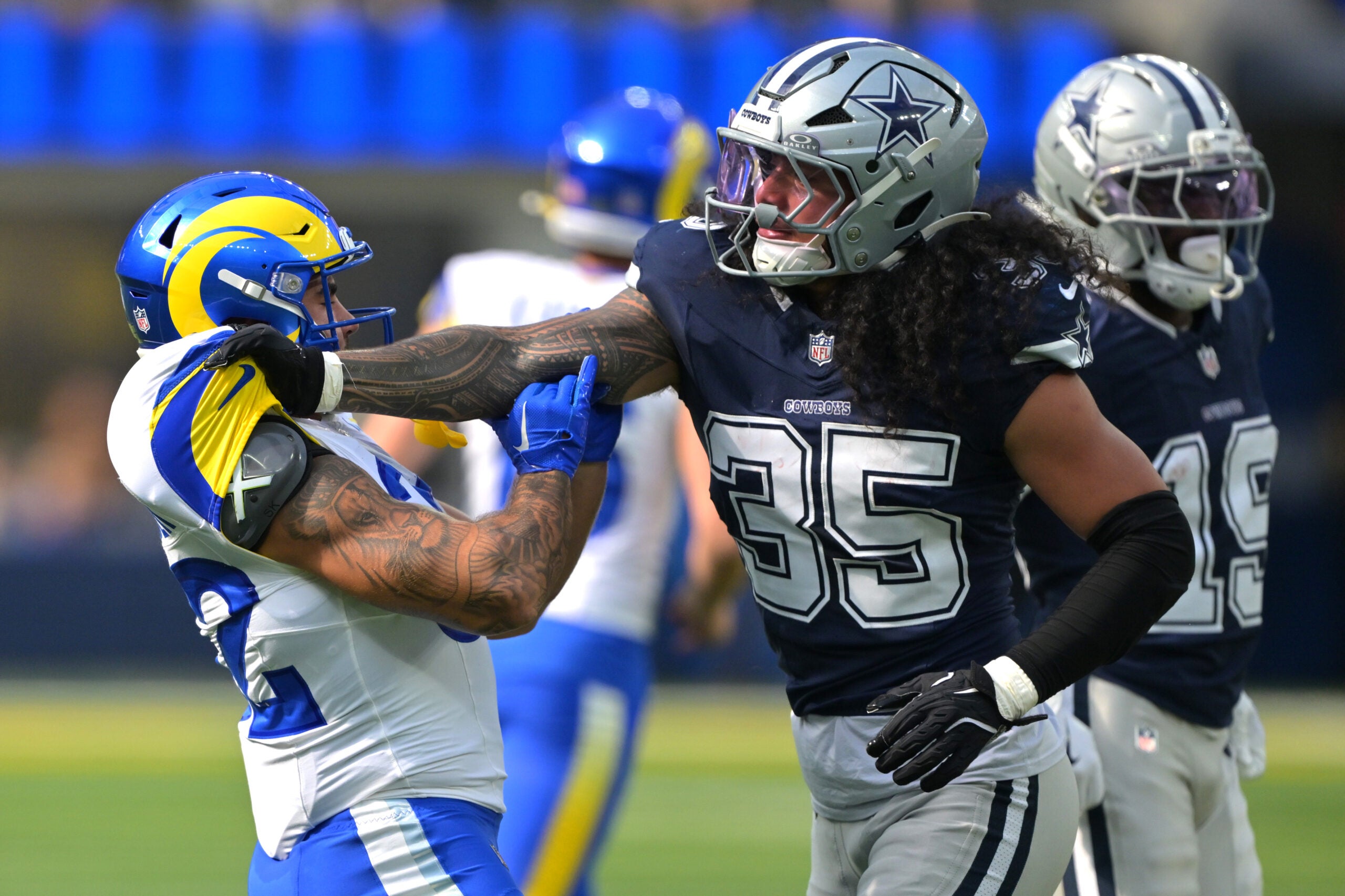 Aug 9, 2025; Inglewood, California, USA; Dallas Cowboys linebacker Marist Liufau (35) grabs a hold of Los Angeles Rams running back Cody Schrader (32) following a play in the first half at SoFi Stadium.