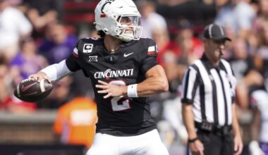 Cincinnati Bearcats quarterback Brendan Sorsby (2) runs as UCF Knights edge Isaiah Nixon (6) attempts to tackle him in the second quarter of the NCAA football game between the Cincinnati Bearcats and UCF Knights at Nippert Stadium in Cincinnati on Oct. 11, 2025.