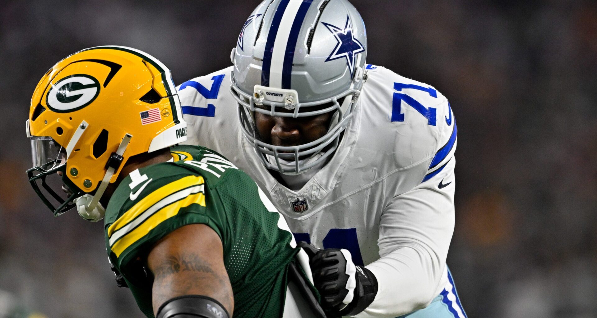 Sep 28, 2025; Arlington, Texas, USA; Dallas Cowboys offensive tackle Nate Thomas (71) blocks Green Bay Packers defensive end Micah Parsons (1) during the game between the Dallas Cowboys and the Green Bay Packers at AT&T Stadium.