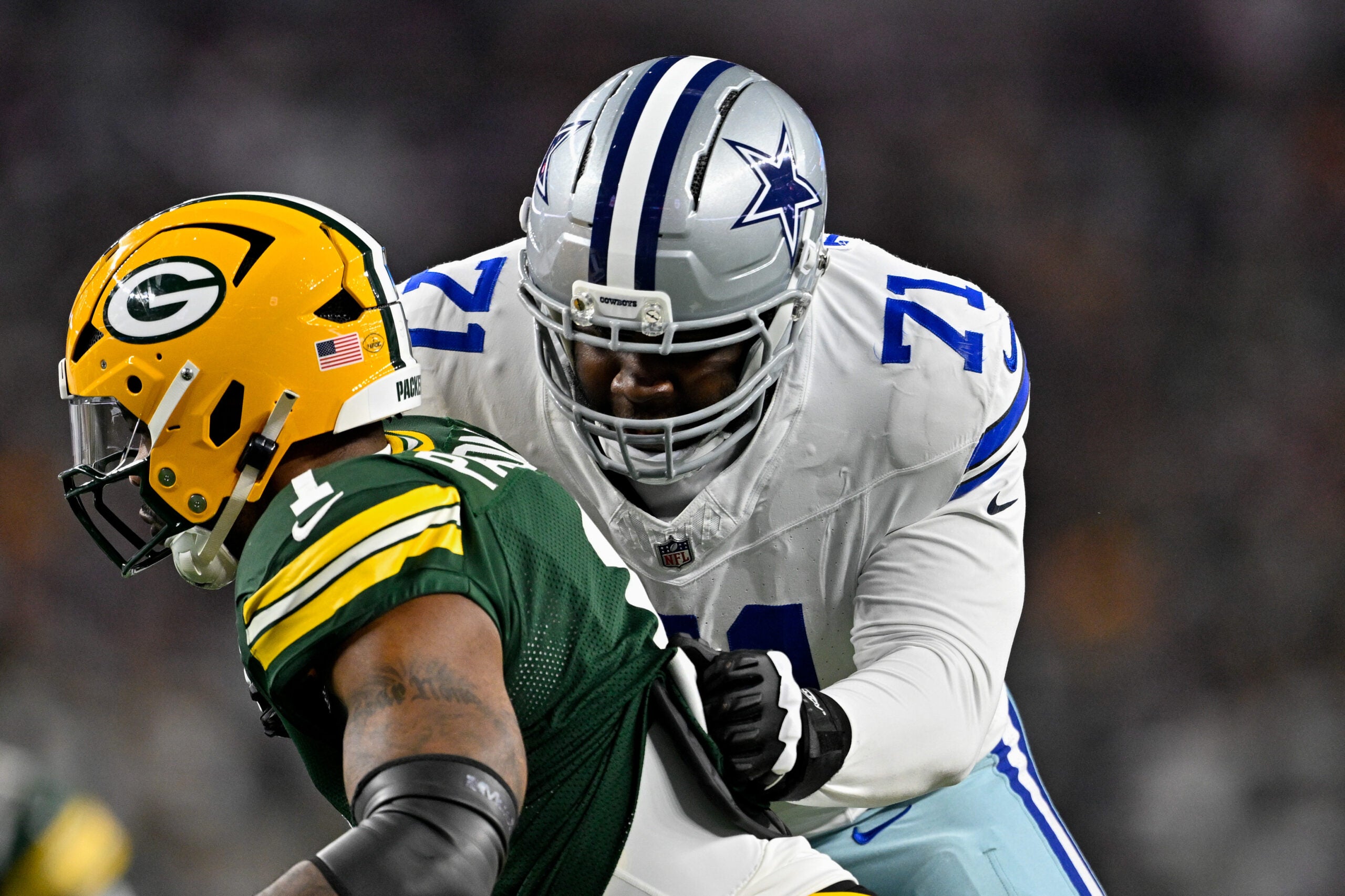 Sep 28, 2025; Arlington, Texas, USA; Dallas Cowboys offensive tackle Nate Thomas (71) blocks Green Bay Packers defensive end Micah Parsons (1) during the game between the Dallas Cowboys and the Green Bay Packers at AT&T Stadium.