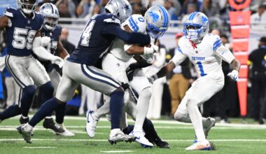 Dec 4, 2025; Detroit, Michigan, USA; Detroit Lions running back Jahmyr Gibbs (0) scores a touchdown against Dallas Cowboys safety Markquese Bell (14) and safety Donovan Wilson (6) during the second half at Ford Field.