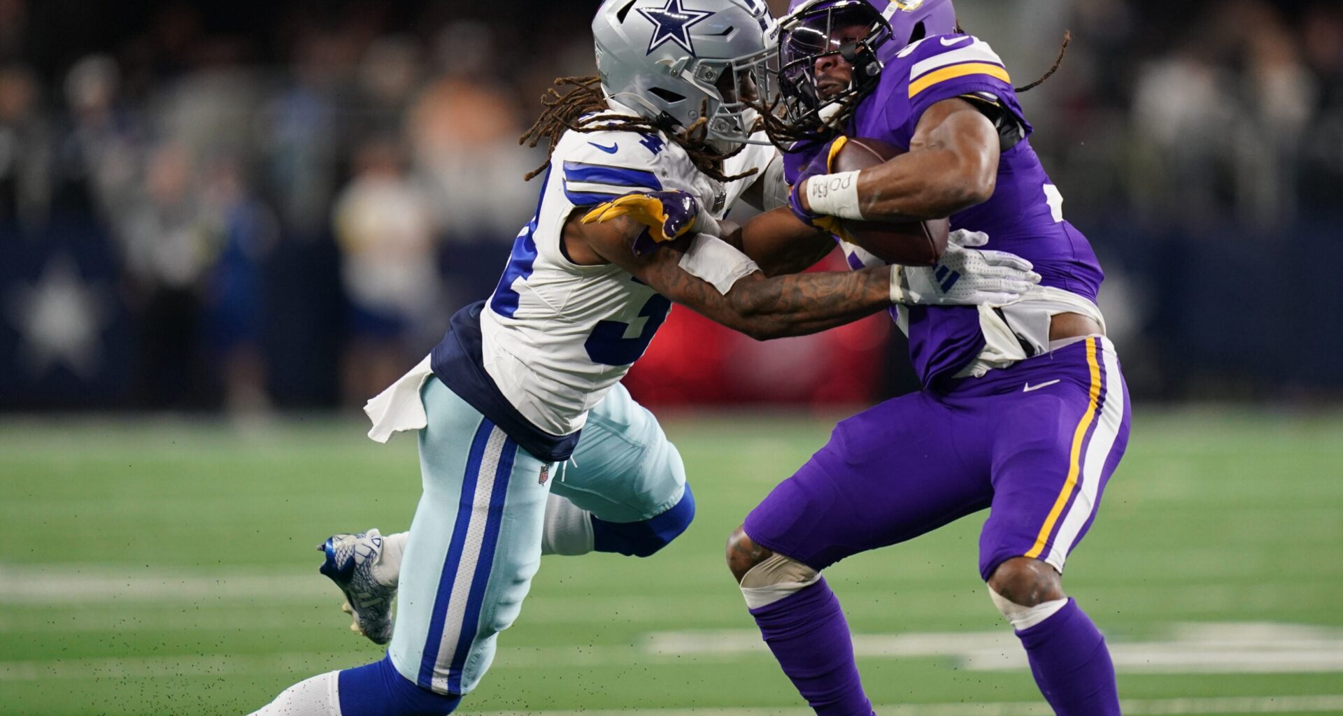 Dec 14, 2025; Arlington, Texas, USA; Dallas Cowboys cornerback Shavon Revel Jr. (34) tackles Minnesota Vikings running back Aaron Jones Sr. (33) during the first half at AT&T Stadium.