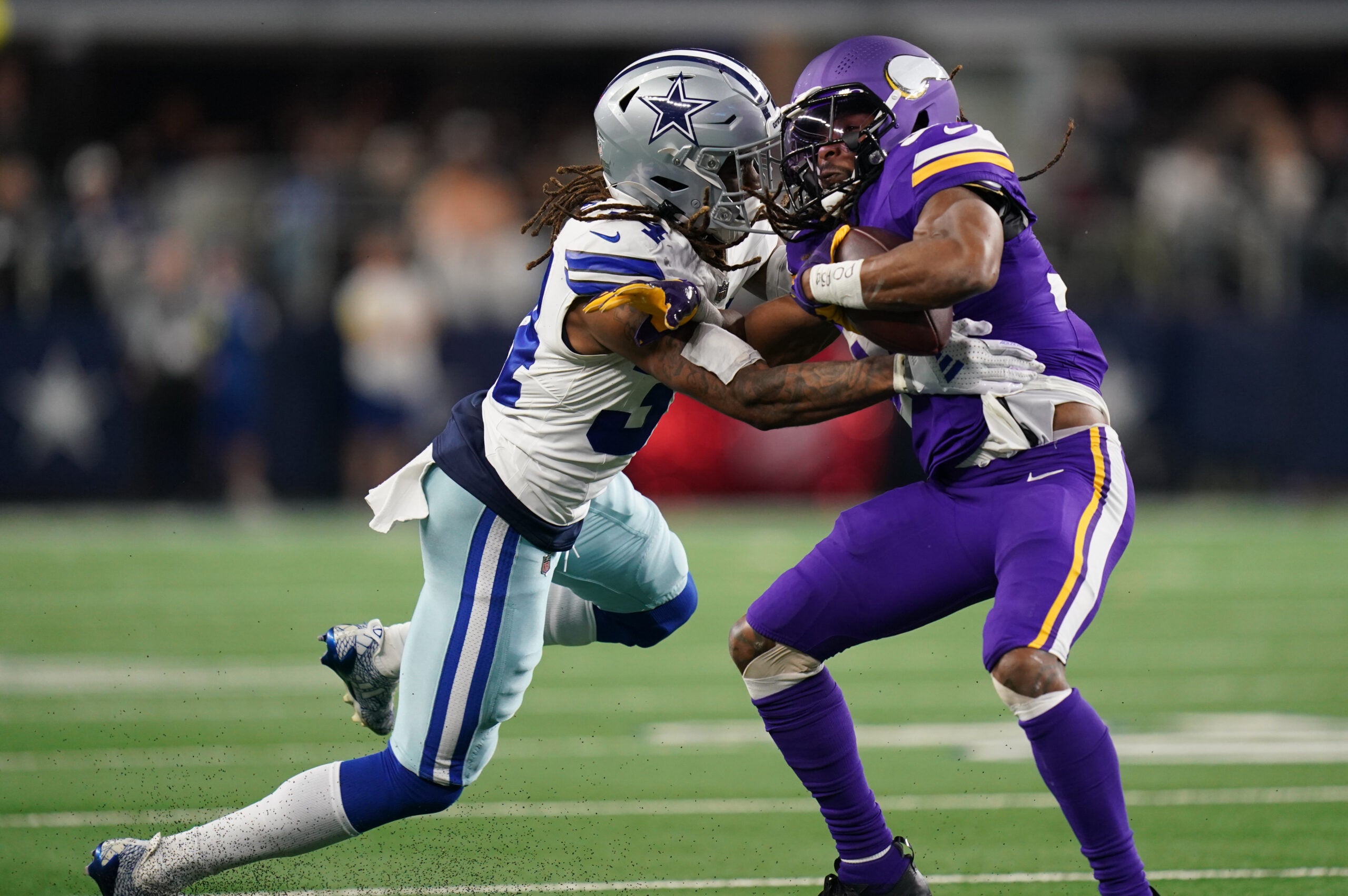 Dec 14, 2025; Arlington, Texas, USA; Dallas Cowboys cornerback Shavon Revel Jr. (34) tackles Minnesota Vikings running back Aaron Jones Sr. (33) during the first half at AT&T Stadium.