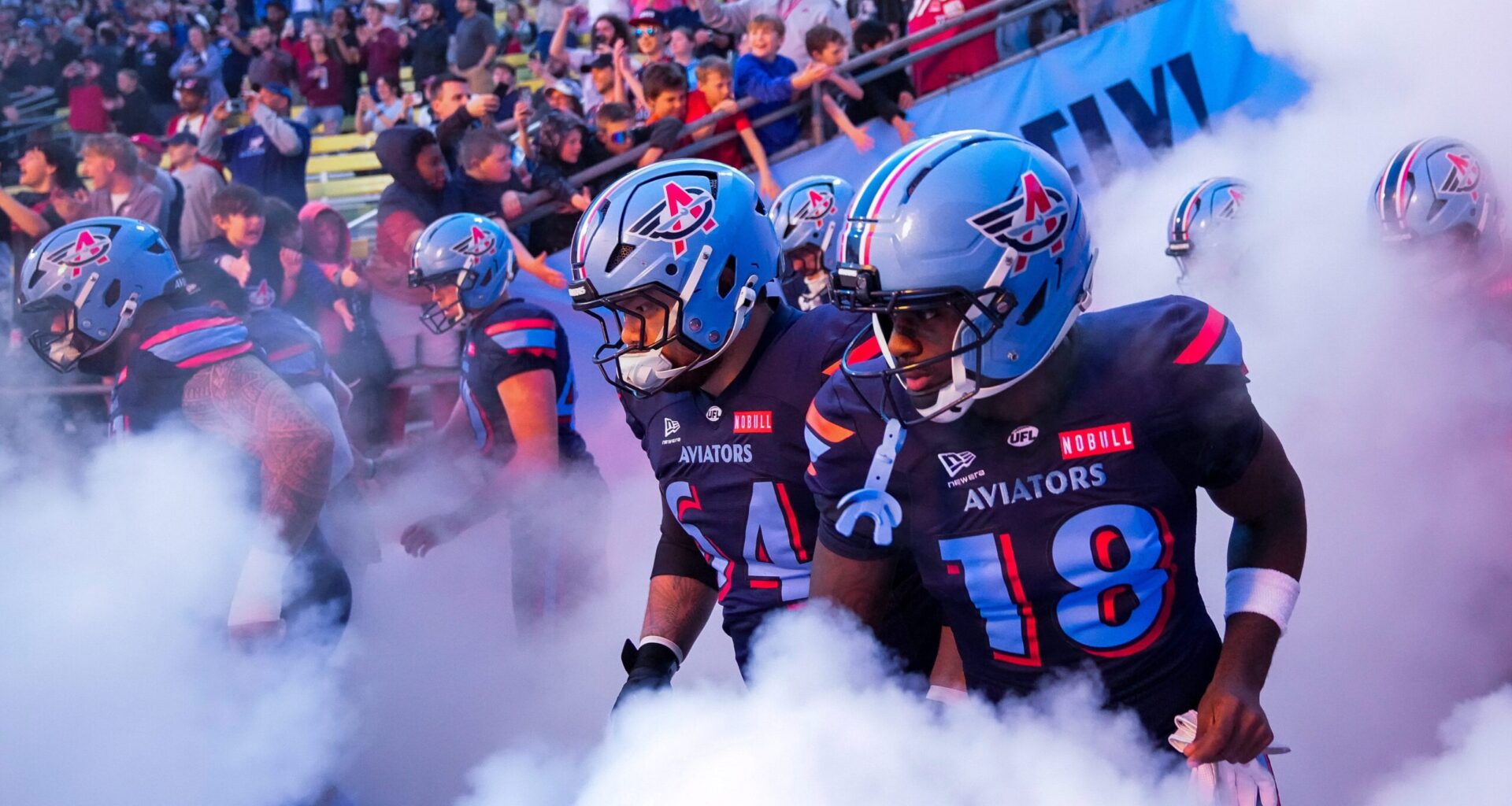 Columbus Aviators guard Chris Glaser (64) and wide receiver Roc Taylor (18) take the field with their teammates before the Columbus Aviators inaugural home game at Historic Crew Stadium on Friday, April 3, 2026 in Columbus, Ohio.
