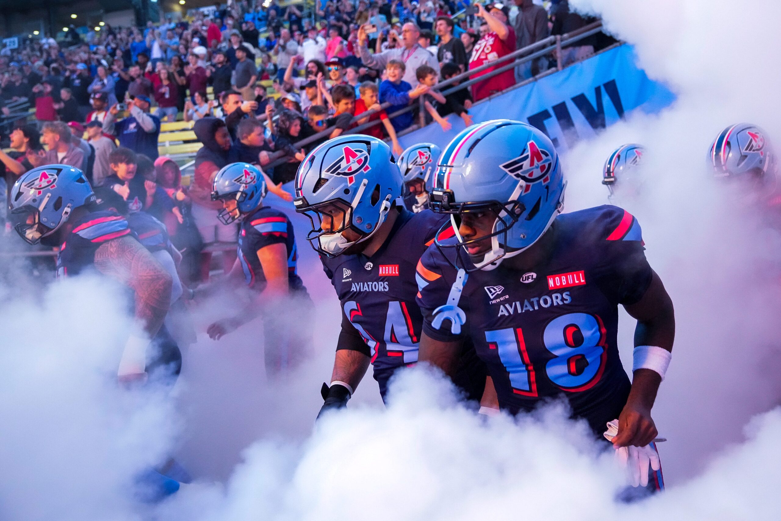 Columbus Aviators guard Chris Glaser (64) and wide receiver Roc Taylor (18) take the field with their teammates before the Columbus Aviators inaugural home game at Historic Crew Stadium on Friday, April 3, 2026 in Columbus, Ohio.