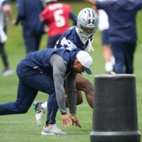 May 1, 2026; Frisco, TX, USA; Dallas Cowboys cornerback Caleb Downs (18) is coached through a drill with defensive coordinator Christian Parker at the Ford Center at the Star Training Facility in Frisco, Texas.