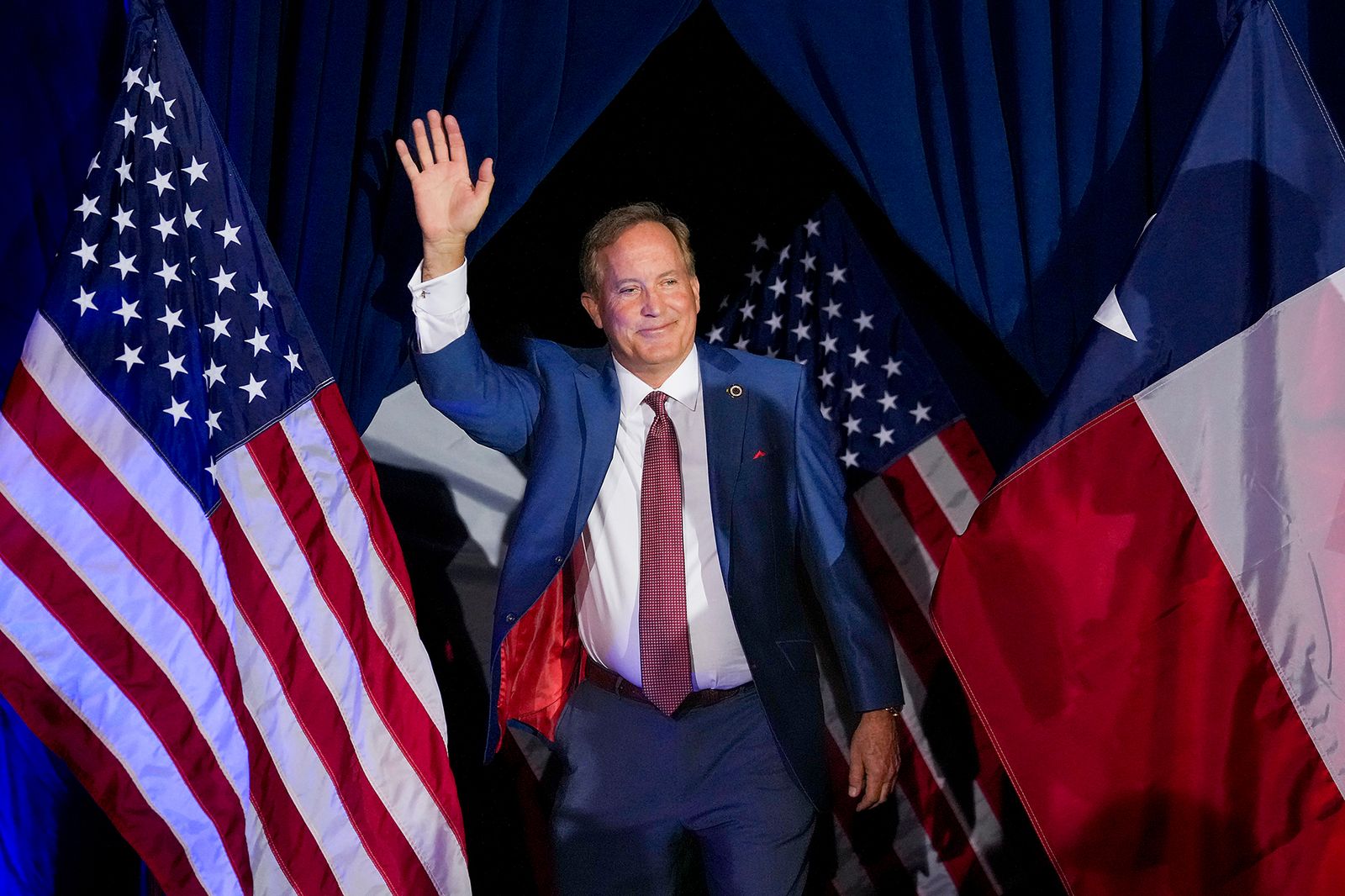 Image may contain Ken Paxton People Person American Flag Flag Adult Accessories Formal Wear Tie and Blazer