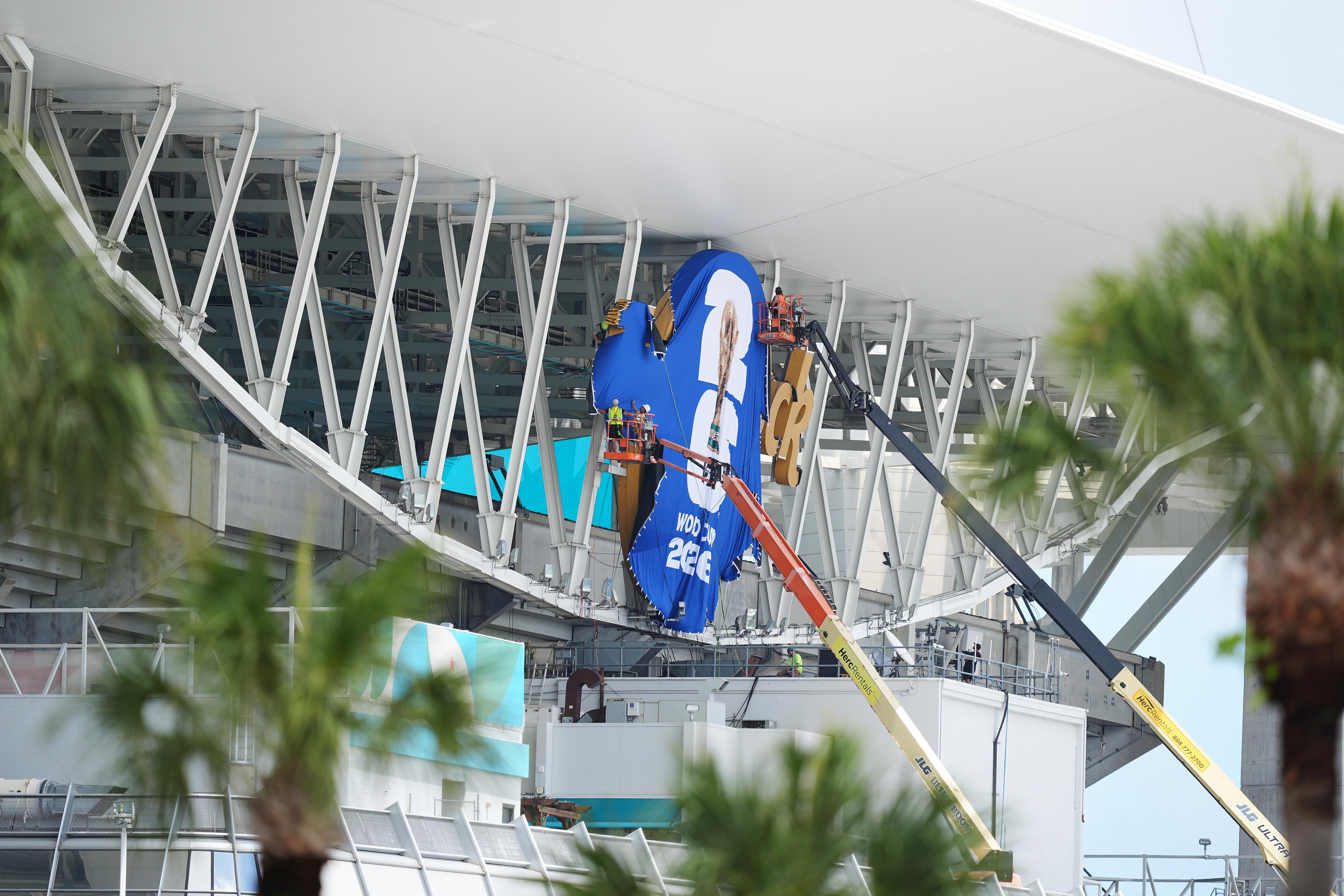 Workers cover Hard Rock Stadium signage with World Cup 2026...