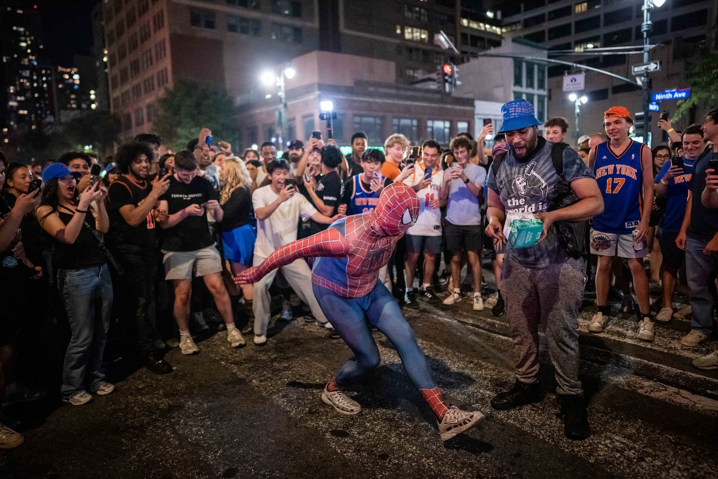 A person dressed as Spiderman dances as New York Knicks fans celebrate their win against San Antonio Spurs in Game 5 of the NBA Finals on June 14, 2026 in New York City. The New York Knicks lead the San Antonio Spurs 3-1 and could win the franchise's first NBA championship since 1973 if they win tonight.