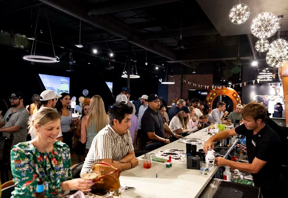 People order drinks during Five Iron Golf's grand opening celebration on Thursday, June 11, 2026 in Fort Worth.