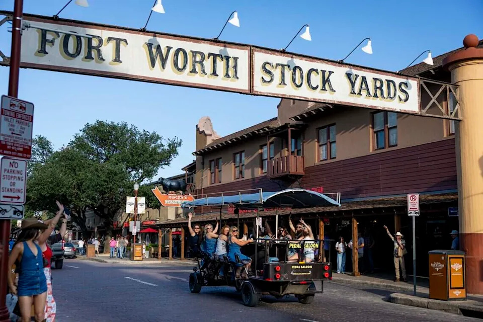 People ride the Pedal Saloon through the Fort Worth Stockyards on Friday, May 22, 2026.