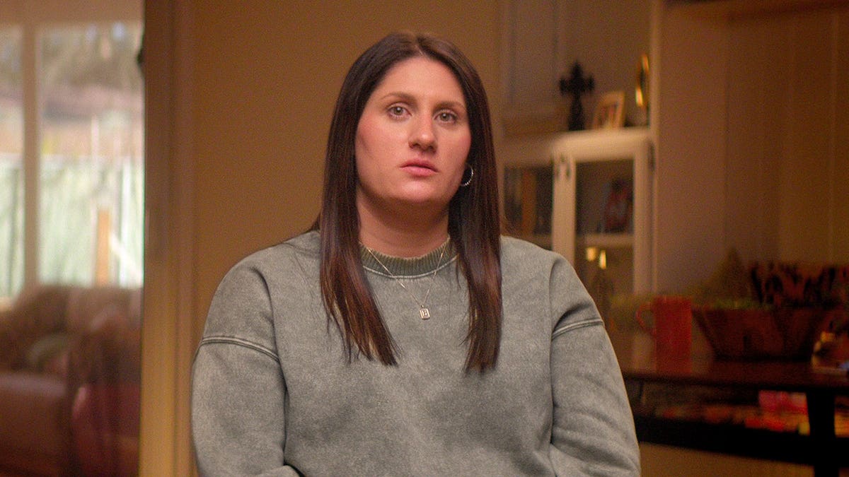 Abby Bell standing in a scene from Maternal Instinct.