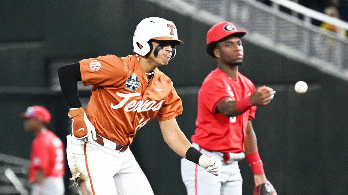 Texas Longhorns shortstop Adrian Rodriguez sliding into second base as Jayden Duplantier flips the ball at Charles Schwab Field