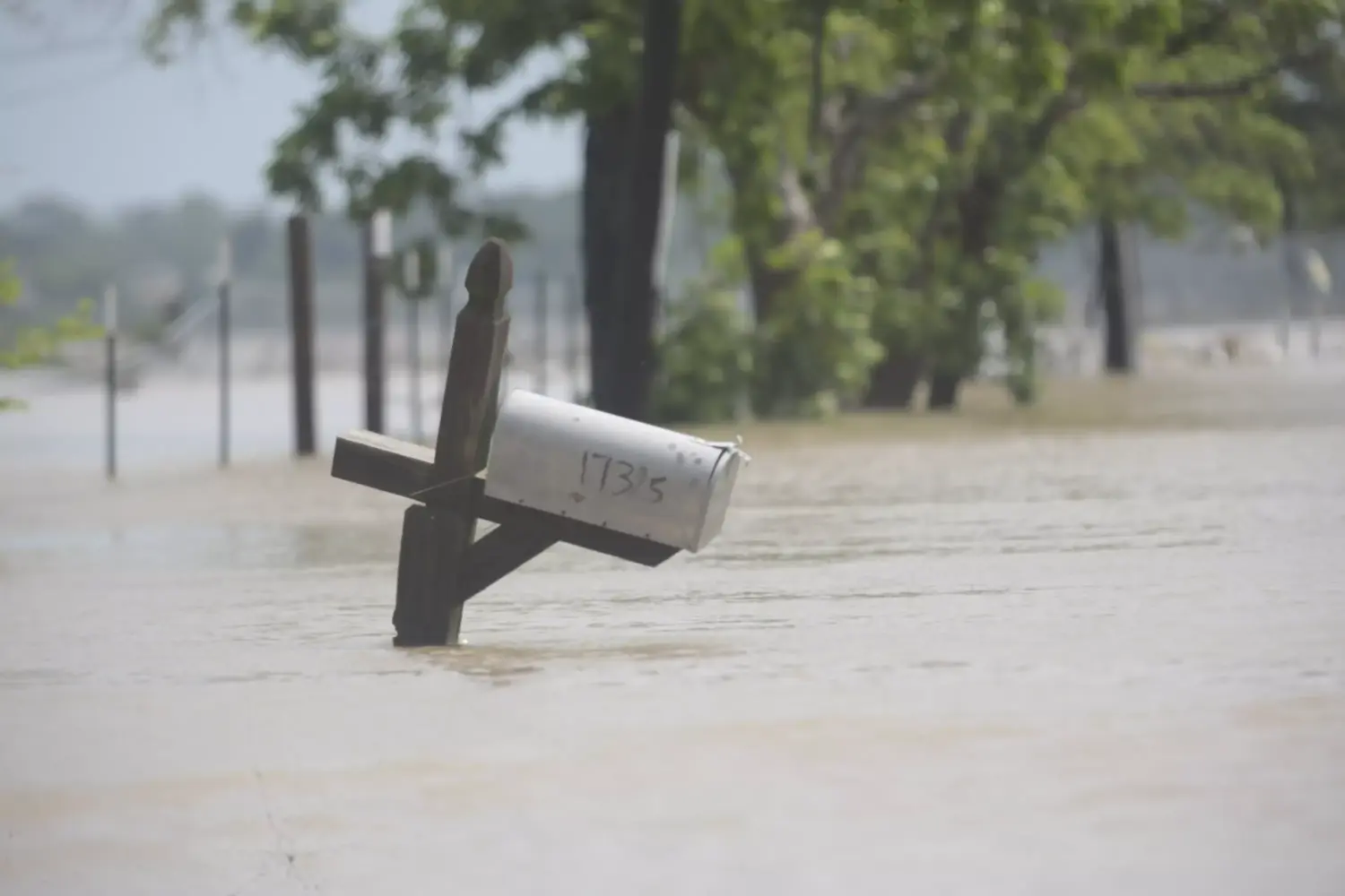 A mailbox is partially submerged on a flooded street in an unincorporated area in east Harris County near Houston on Sunday morning, May 5, 2024.