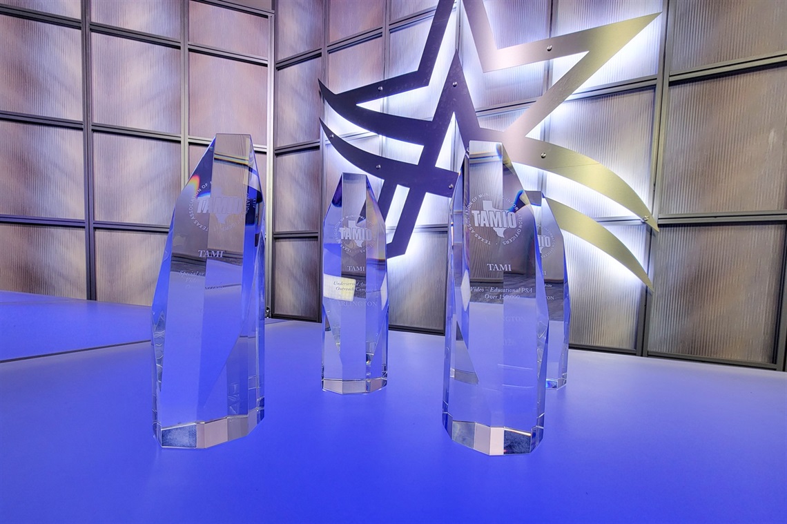 Six trophies in front of the Arlington logo