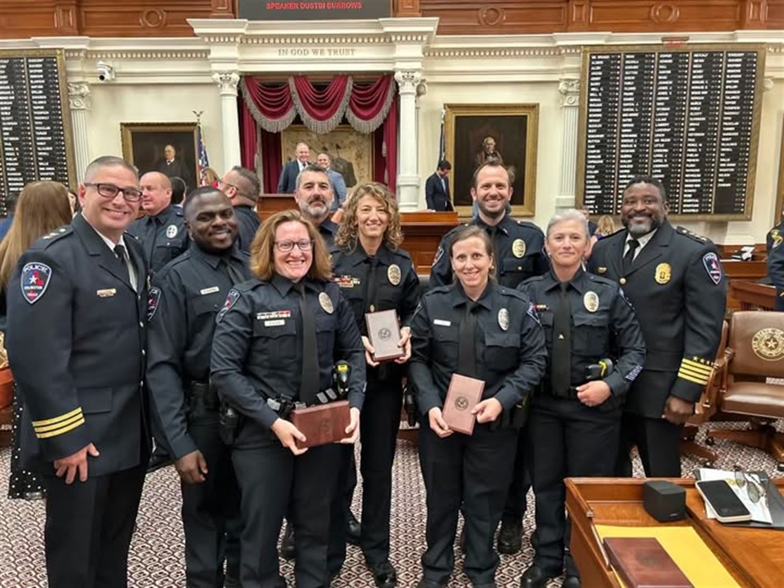 APD Homicide Unit posing with awards inside the State Capitol