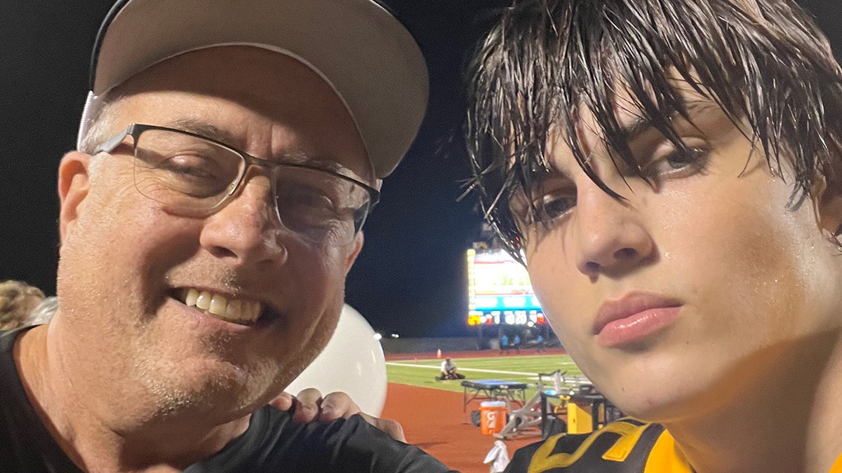 Jeff Metcalf standing with his son Austin Metcalf outdoors