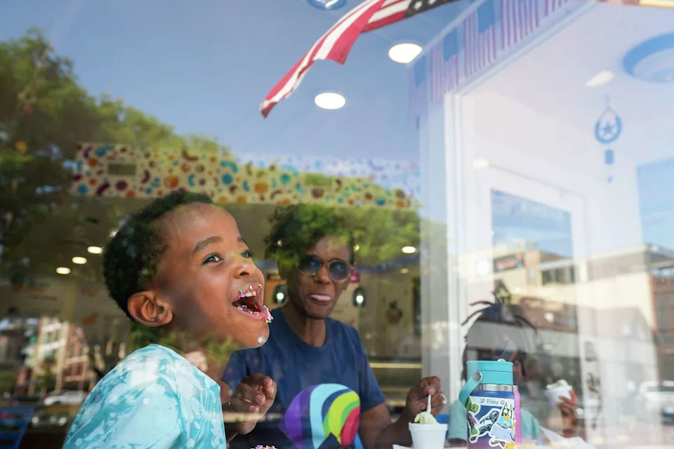 Riley Holloway III, 6, laughs while having ice cream with his grandmother Terrie Slaughter and sister Bailey Holloway, 8, at The Gelato Cone on Wednesday, May 31, 2023, in Downtown Plano. (Smiley N. Pool/Dallas Morning News)