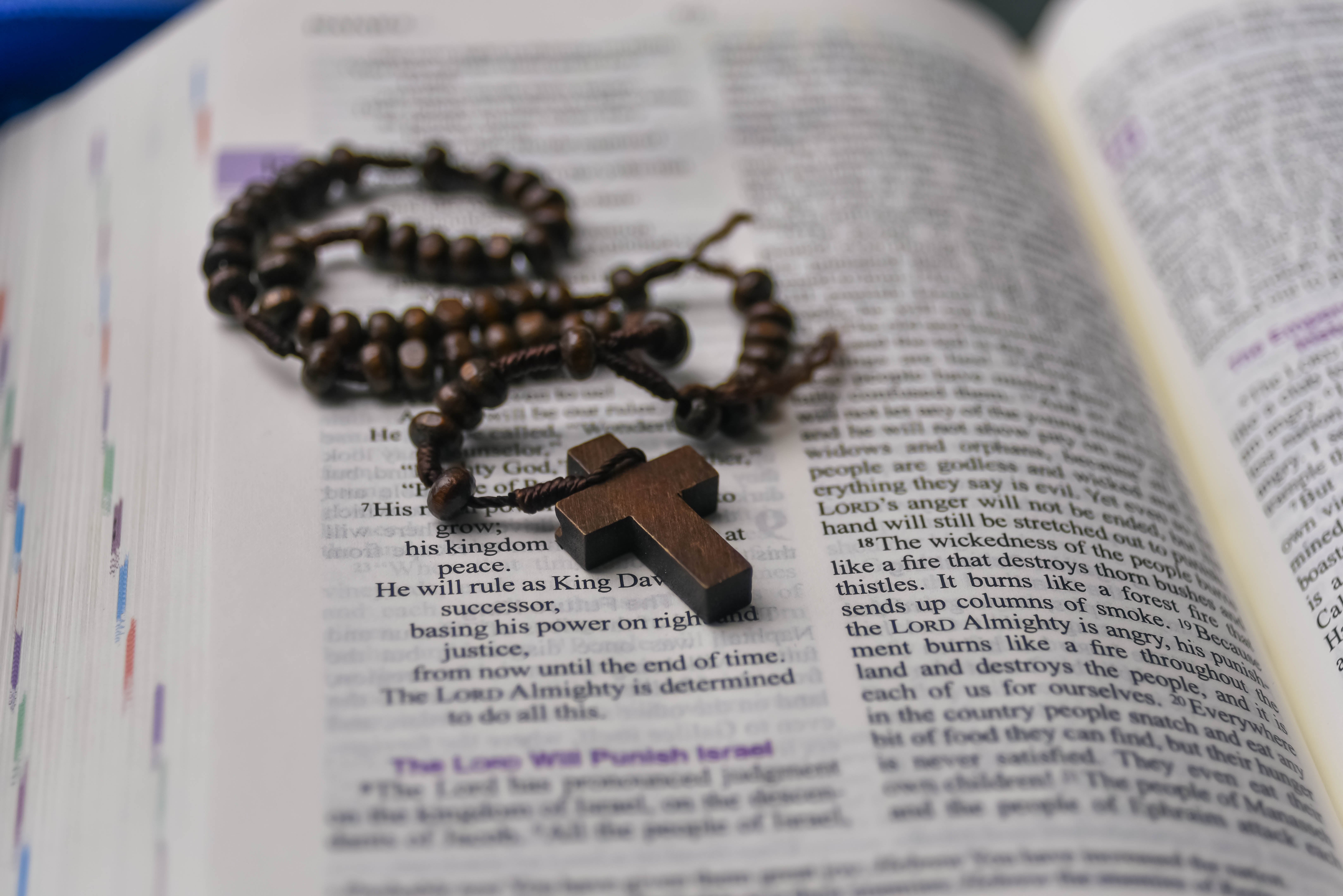 Open Bible with a rosary laid across the pages, highlighting religious text