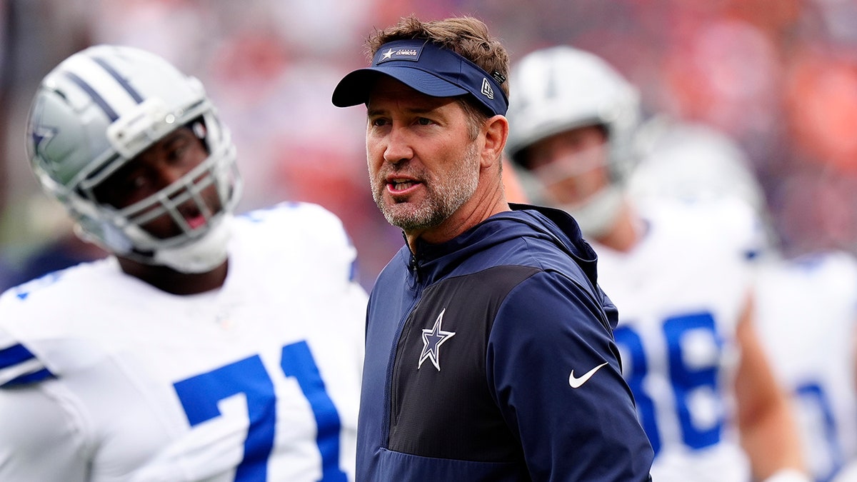 Dallas Cowboys head coach Brian Schottenheimer looking on before a game at Empower Field at Mile High in Denver
