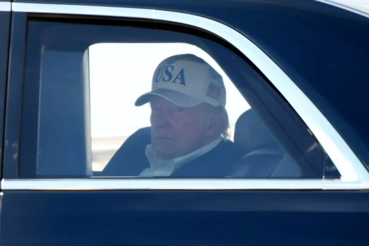 President Donald Trump sits in his limousine, known as The Beast, after arriving on Marine One at Joint Base Andrews, Md., Sunday, June 21, 2026, following a trip to Camp David. (AP Photo/Mark Schiefelbein)