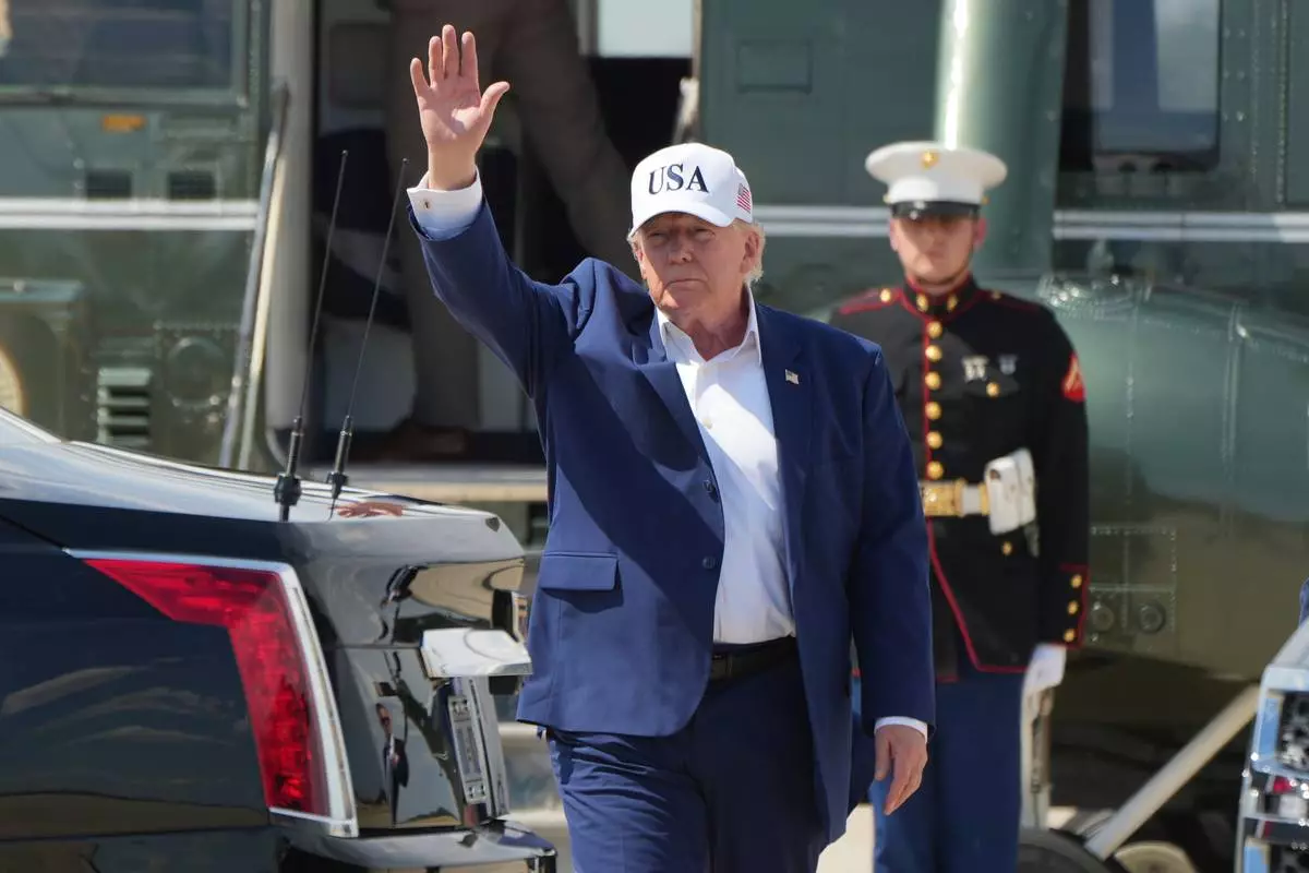 President Donald Trump waves as he arrives on Marine One at Joint Base Andrews, Md., Sunday, June 21, 2026, following a trip to Camp David. (AP Photo/Mark Schiefelbein)