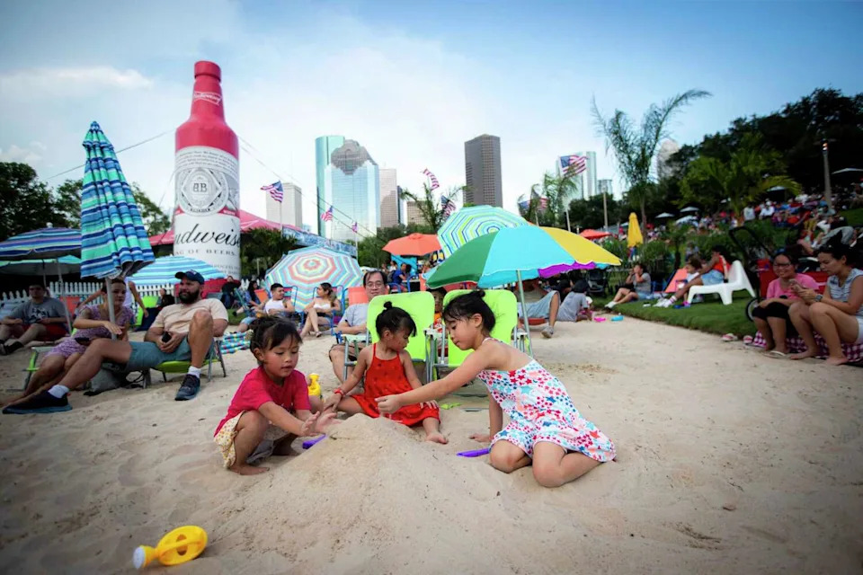 Families play on sand beaches during the annual Freedom Over Texas festival on the Fourth of July, Thursday, July 4, 2024, in Houston. (Ishika Samant/Staff photographer)