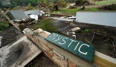 A Camp Mystic sign is seen near the entrance to the establishment along the banks of the Guadalupe River in Hunt, Texas, Saturday, July 5, 2025, after a flash flood swept through the area. (AP Photo/Julio Cortez)