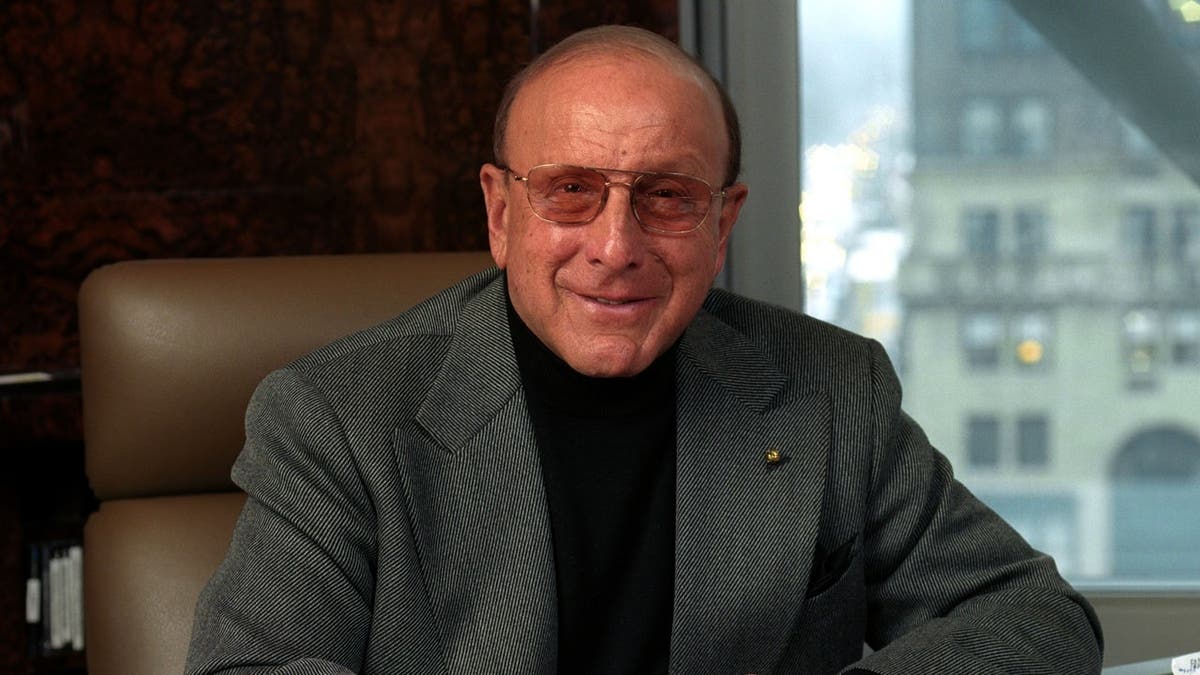 Clive Davis standing and smiling in New York City.