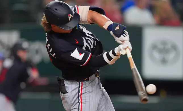 Minnesota Twins' Luke Keaschall hits a single scoring teammate Josh Bell during the fourth inning of a baseball game against the Texas Rangers, Tuesday, June 16, 2026, in Arlington, Texas. (AP Photo/LM Otero)