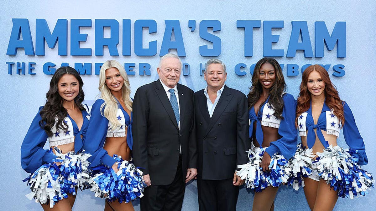 Reece Weaver and Sophy Laufer of Dallas Cowboys Cheerleaders stand with Jerry Jones, Ted Sarandos, Camille Sturdivant, and Charly Barby at a premiere event.