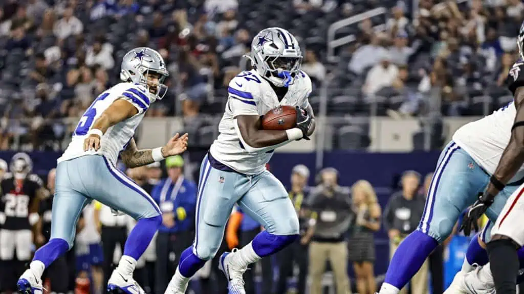 Dallas Cowboys running back Phil Mafah takes a handoff and follows his blockers upfield, demonstrating the vision and patience he has brought to the competition for a roster spot.