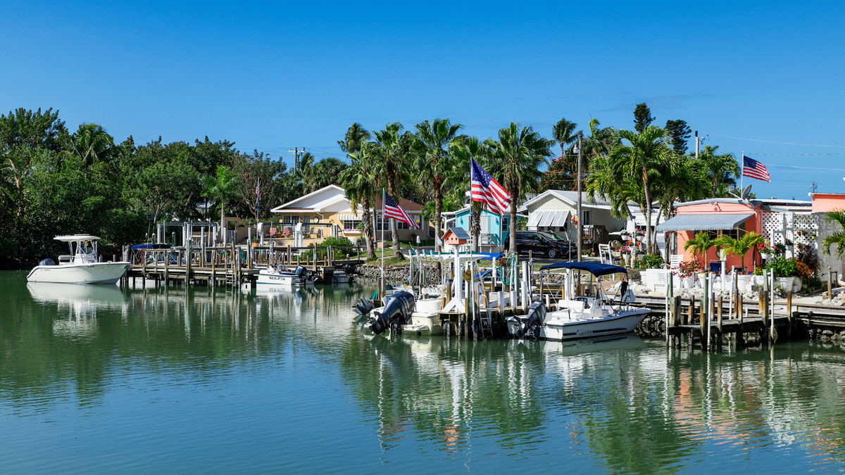Boats are docked near waterfront homes in Florida, one of the nation's fastest-growing states and a major destination for Americans seeking lower taxes and a lower cost of living.