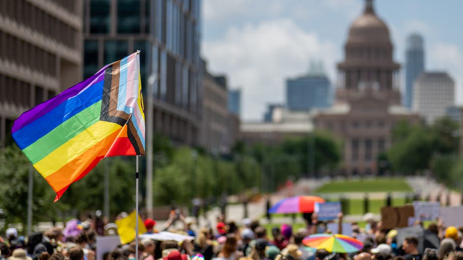A Pride flag is seen held up in a crowd during preparation for a Queer March to the Texas State Capitol on April 15, 2023 in Austin, Texas.