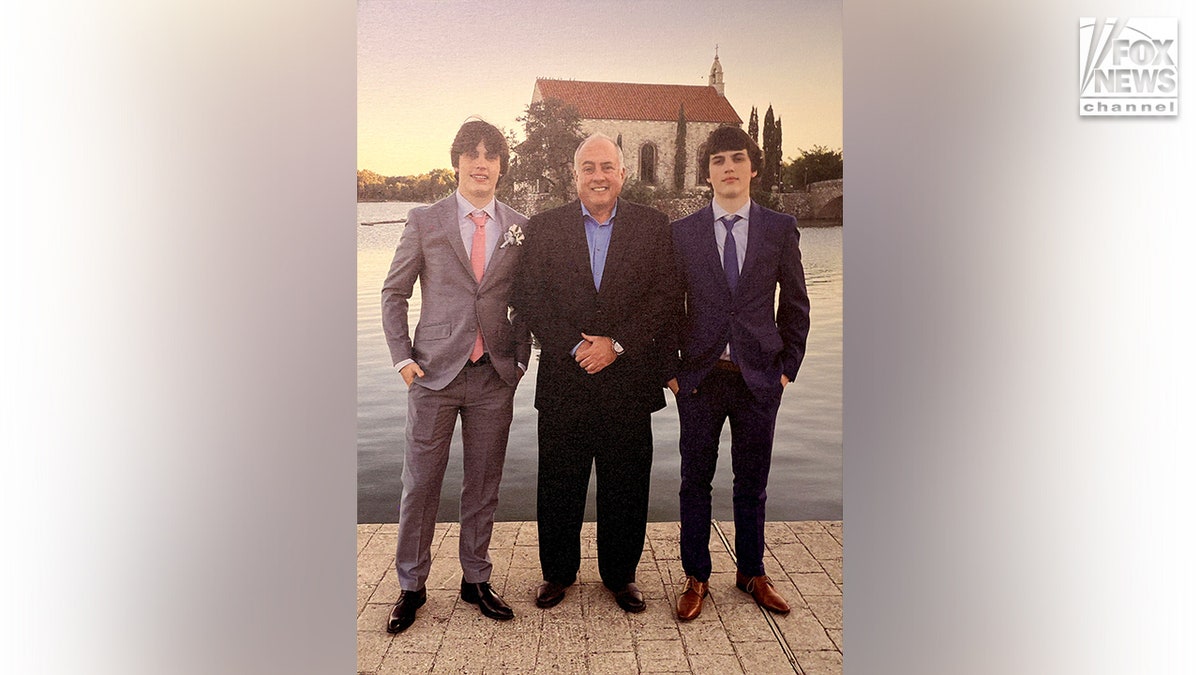 Jeff Metcalf standing with his sons Austin and Hunter Metcalf in a family photo at their home in Frisco, Texas