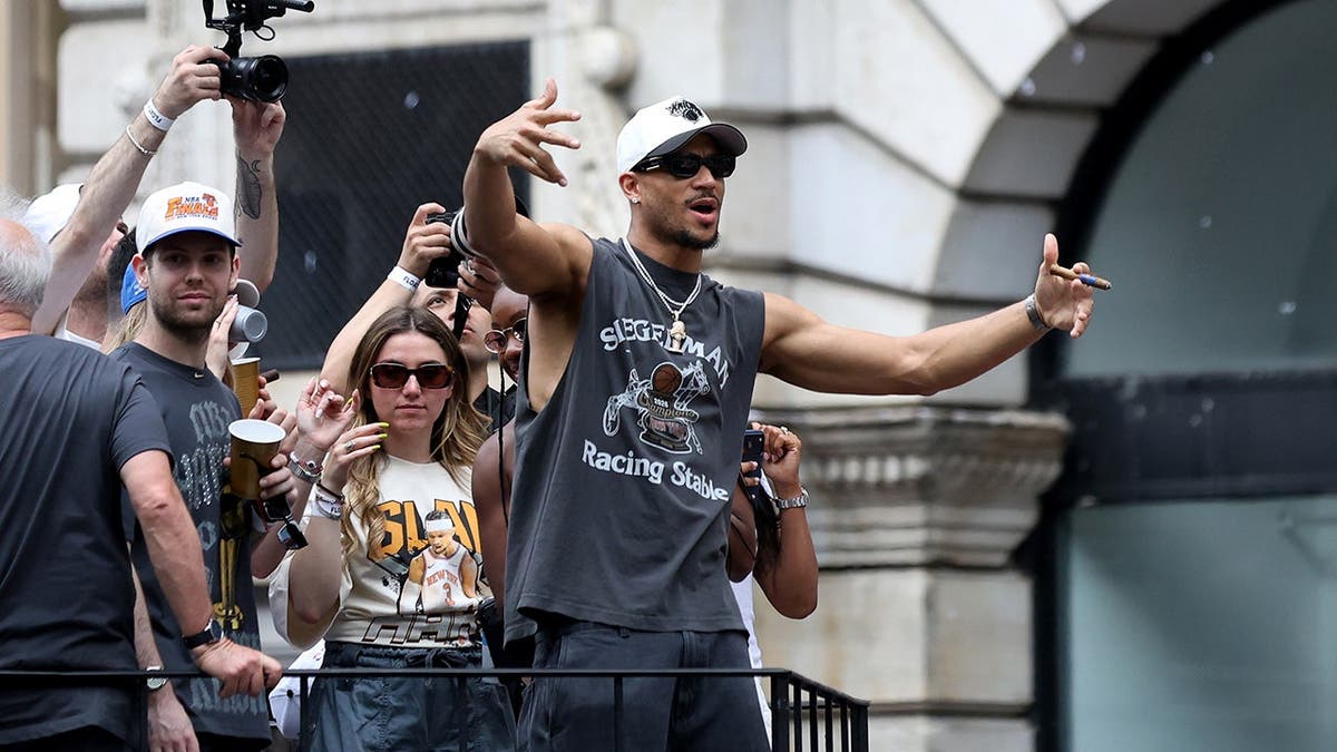 New York Knicks guard Josh Hart celebrating on a parade float in New York
